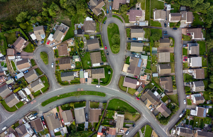 Ariel view of the roof of houses that are part of a of a self-managed HOA with greenery and streets in the neighborhoods